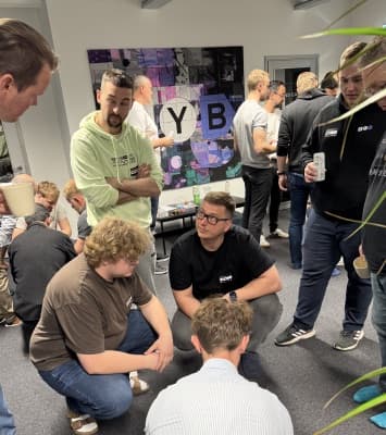 XYB colleagues talking in the London office